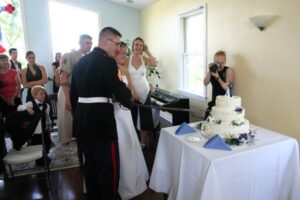 military wedding cutting cake with a sword after planning a military wedding